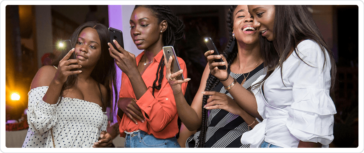 Four women engaging with smartphones